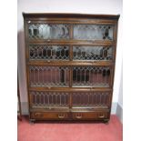 An Early XX Century Oak Four Height Sectional Bookcase, with leaded glazed sliding doors, two