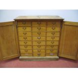 An Early XX Century Oak Cabinet, with twin panelled doors concealing three banks of eight drawers,
