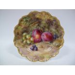 A Royal Worcester China Plate, of shaped circular form, painted and gilt with plums and grapes on