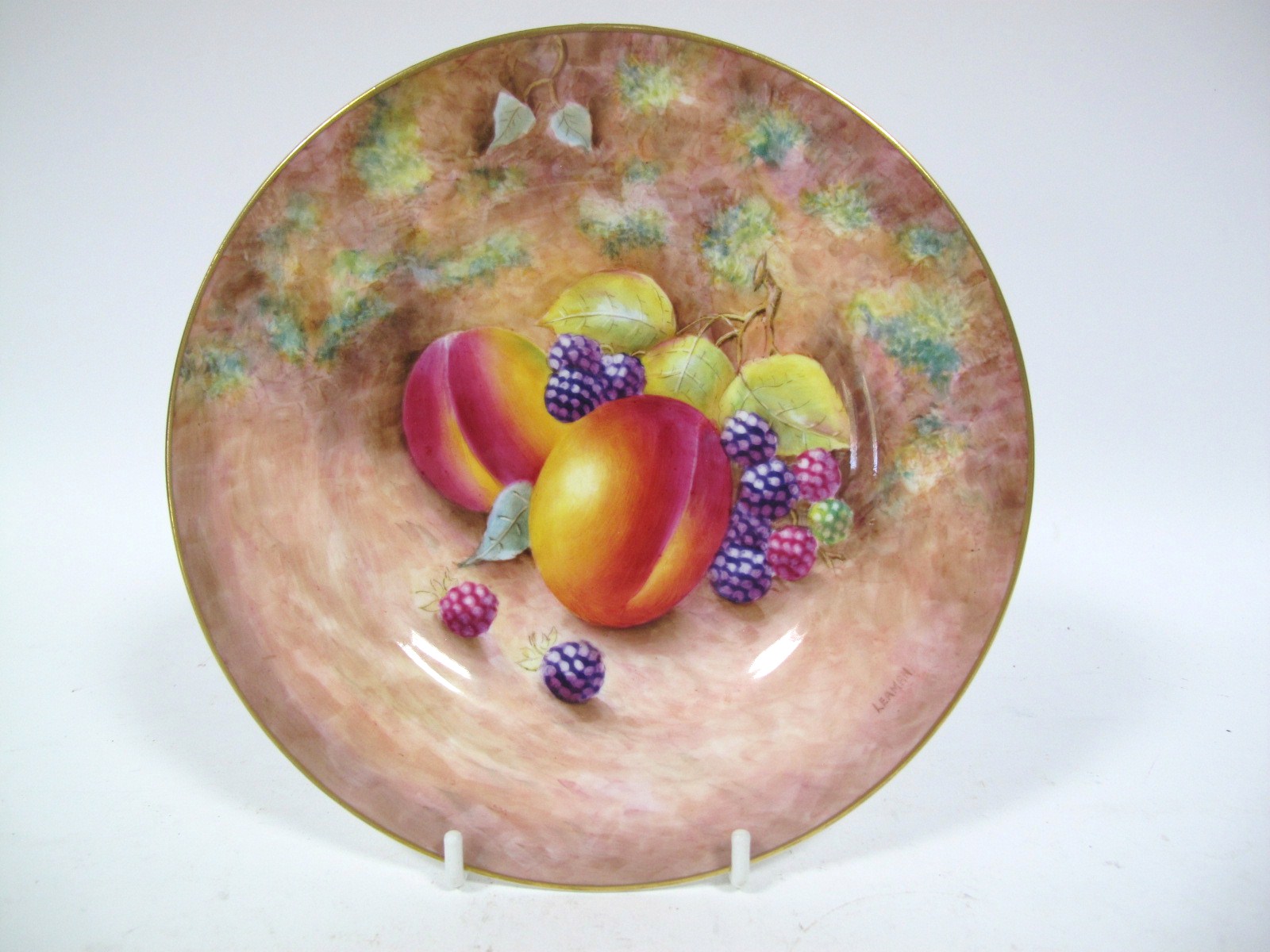 A Royal Worcester China Plate, painted and gilt with peaches and blackberries on a naturalistic