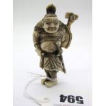 A Late XIX Century Japanese Ivory and Horn Netsuke, as a robed figure, wearing a sword, holding a