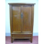 A XIX Century Chinese Elm Wardrobe, with cushion shaped cornice, twin panelled doors with brass back