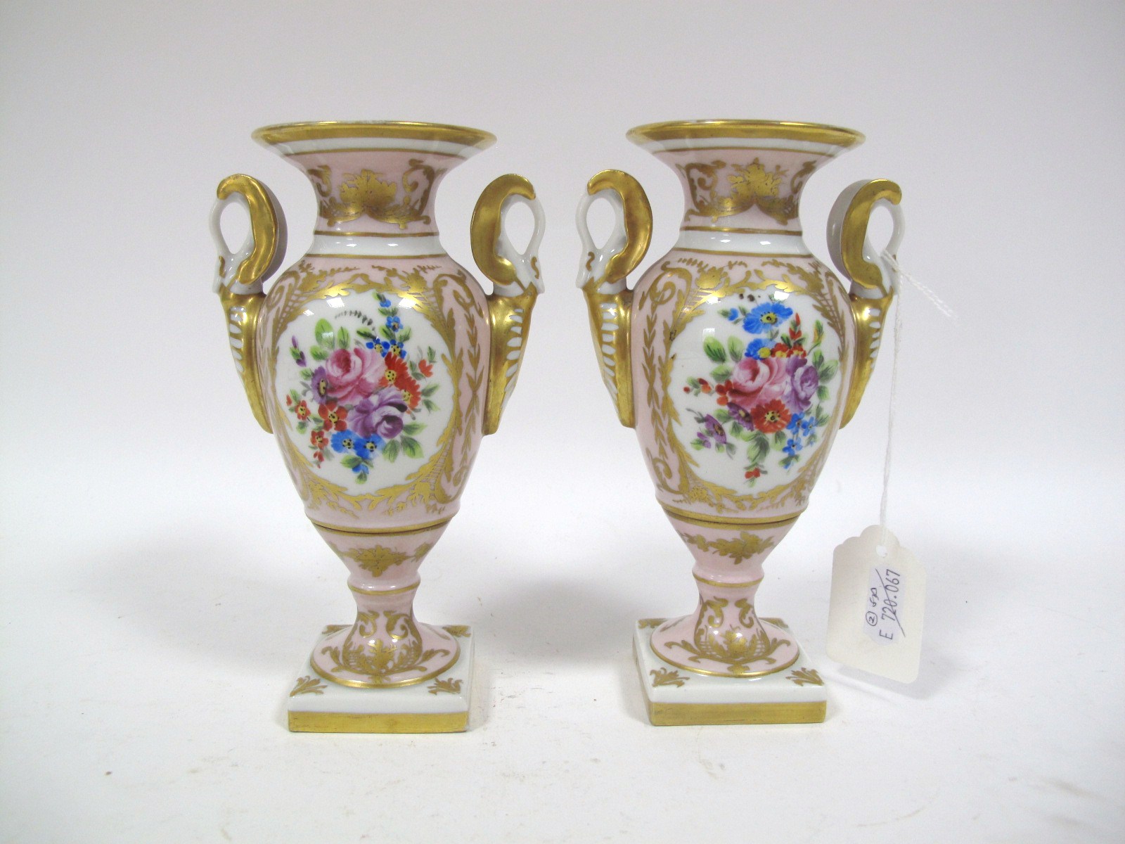 A Pair of Limoges Twin Handled Campana Style Vases, each with hand painted floral panels on pink