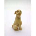 A XIX Century Craved Ivory Netsuke, in the form of a dog, 3.8cms high.