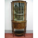 An Edwardian Inlaid Serpentine Shaped Display Cabinet, the central door with floral decoration,