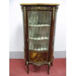 A XX Century French Serpentine Shaped Mahogany Vitrine, with a marble top, the frieze with ormolu