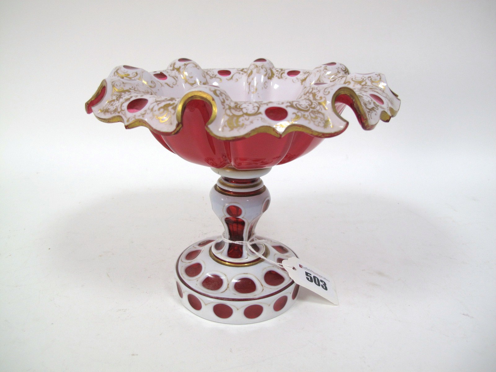 A XIX Century Ruby and White Overlaid Bohemian Glass Pedestal Dish, the ribbed and shaped top cut