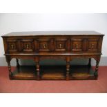 A XVII Century Style Oak Dresser Base, with three moulded front drawers and shaped apron on turned