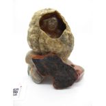 A Chinese Carved Hardstone Geode, internally with a seated figure, on a carved and polished