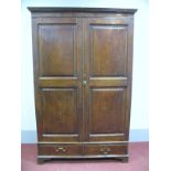 A Late XVIII Century Mahogany Wardrobe, the top with dentil cornice over twin panelled doors, on