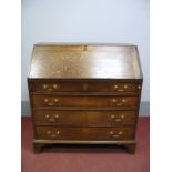 A Late XVIII Century Oak Bureau, with a crosbanded fall to fitted interior above four long drawers