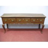 A Mid XVIII Century Style Oak Dresser Base, the top with moulded edge, three small drawers, shaped