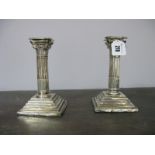 A Pair of Corinthian Column Candlesticks, each on stepped base, with removable nozzle. (2)