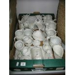 A Large Quantity of White Opaline Lustre Pottery, including tea ware, candlesticks, figures,