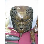 A Large Hardwood Carved African Face Mask, stylised features flanked by pierced decoration of