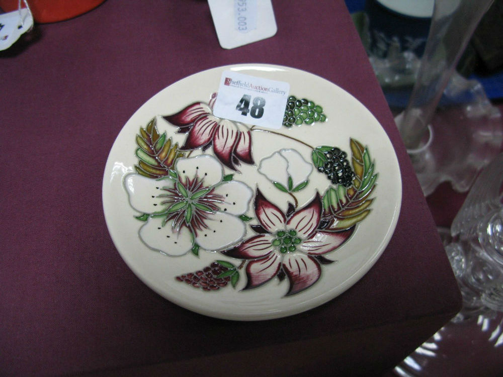 A Moorcroft Pottery Coaster, decorated with the "Bramble Revisited" design by Alicia Amison, shape