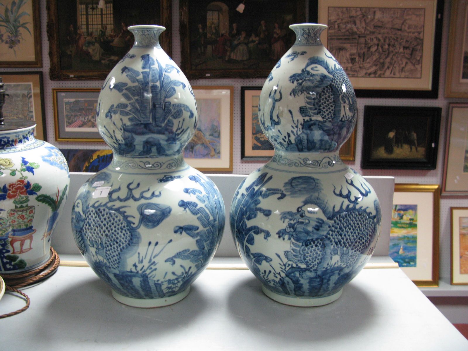 A Pair of Large Chinese Blue and White Pottery Double Gourd Vases, each featuring dragons and