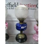 Early XX Century Oil Lamp, having fourteen sided blue glass well, on wrythen brass support and black