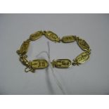 An Egyptian Bracelet, composed of eight cartouche panels, to clasp stamped "750".