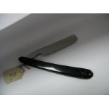 A c.1850 Patent Lock Razor, tortoiseshell scales inset with oblong shield, 3/4" blade, rounded