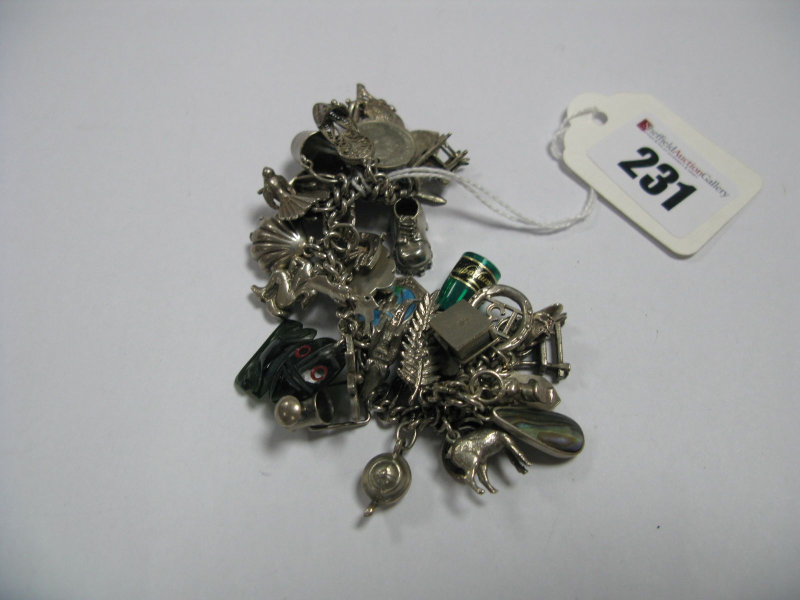 A Curb Link Charm Bracelet, suspending numerous novelty charm pendants.