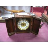 An Early XX Century Carriage Clock, with a carrying handle, release button, circular dial, on bun