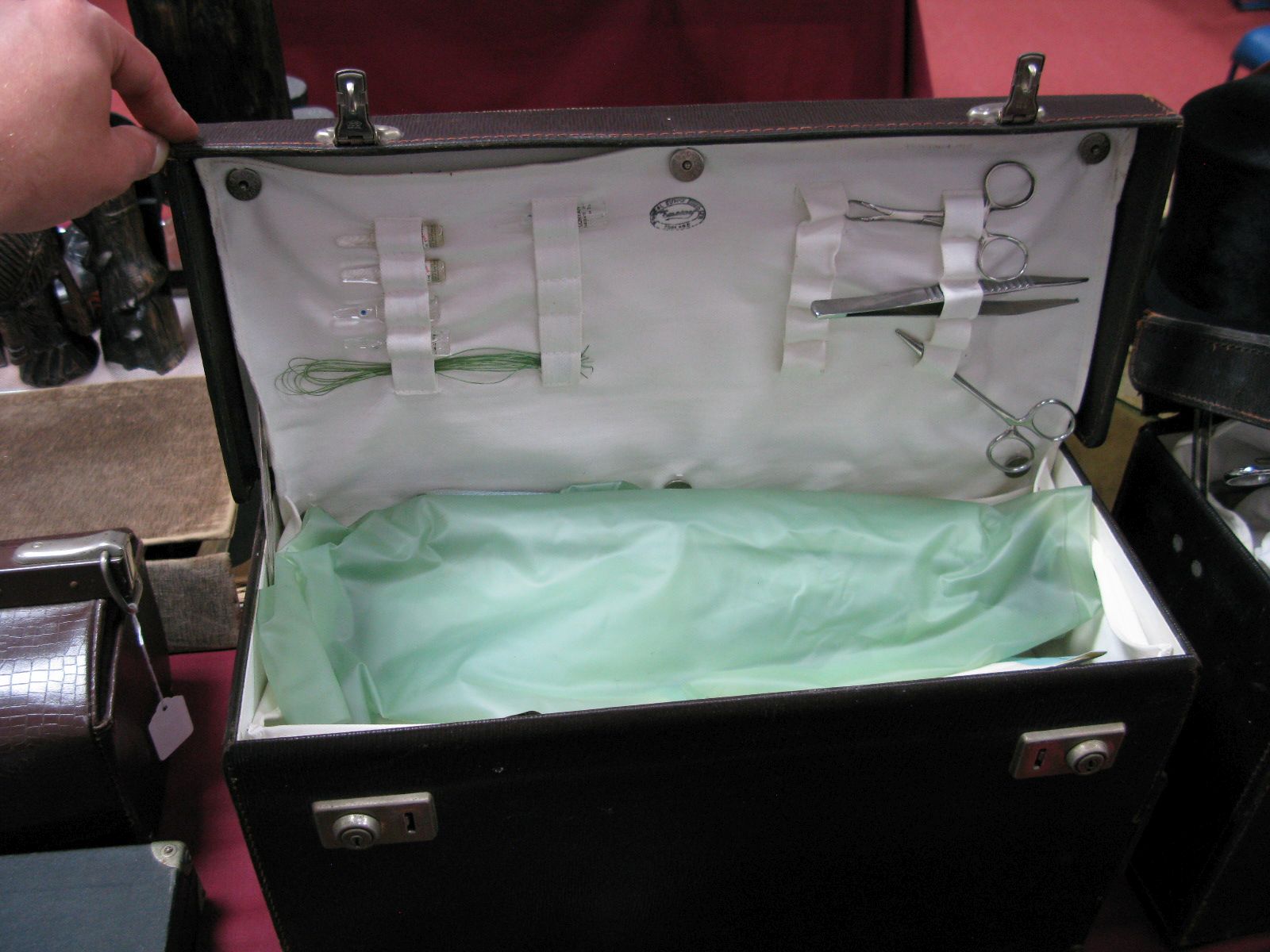 A Leather Doctors Travelling Case, containing Skidmore stainless steel medical implements and