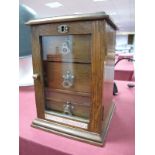 A Miniature Oak Three Drawer Cabinet, with lockable glazed door, with carry handle. Plaque to