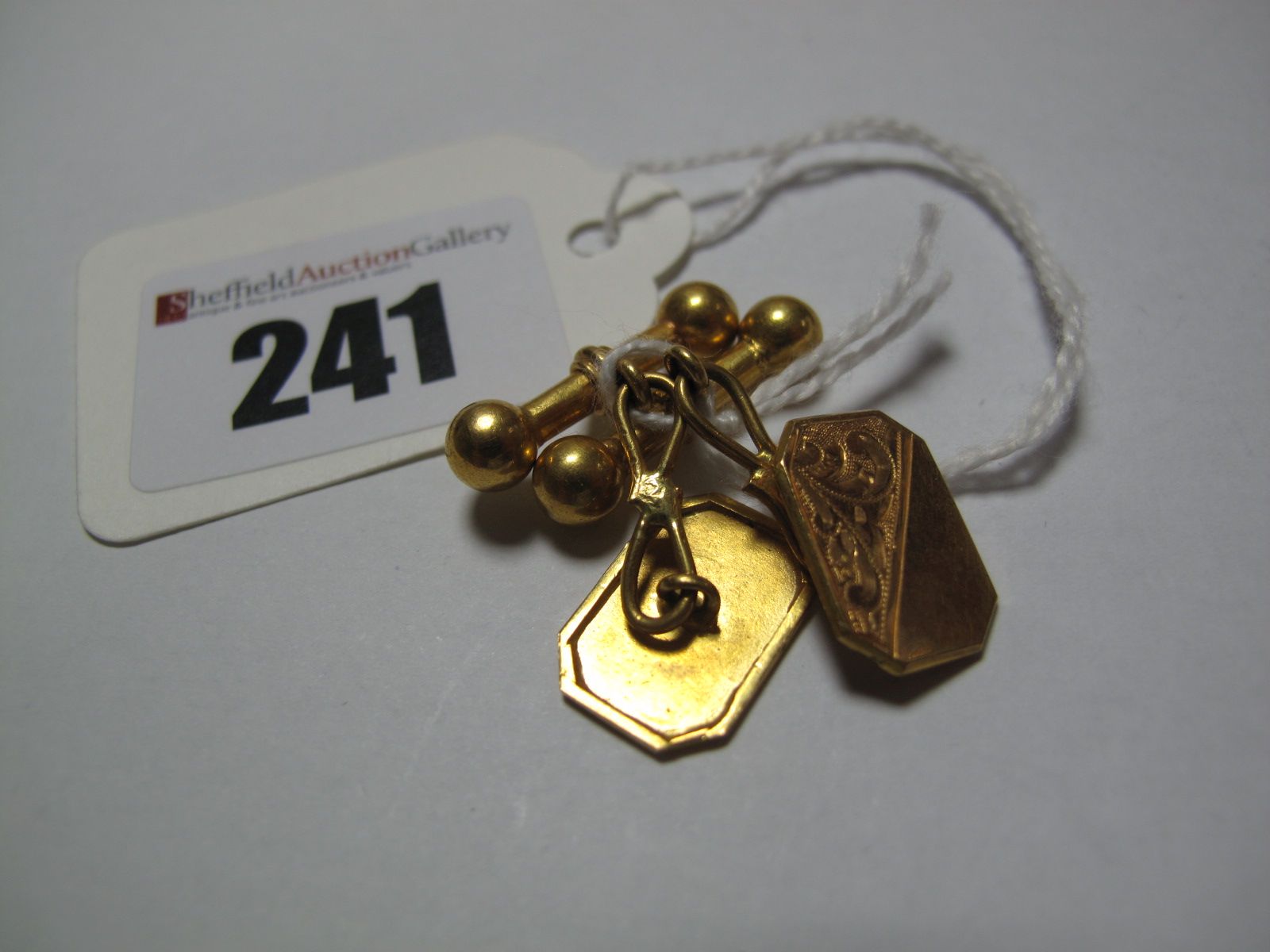 A Pair of Gent's Cufflinks, each rectangular panel with canted corners and engraved detail, on bar