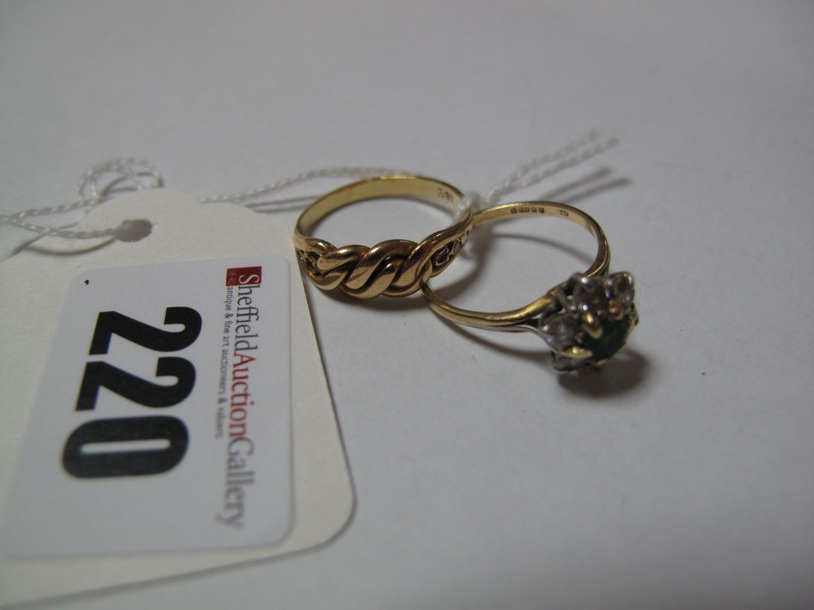 An 18ct Gold Cluster Ring, claw set, together with another ring, of curb link design with inset