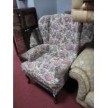 A Pair of Armchairs, upholstered in floral fabric, on cabriole legs.