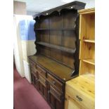 A Later XX Century Oak Dresser, moulded edge with shaped apron piece and two shelves over three