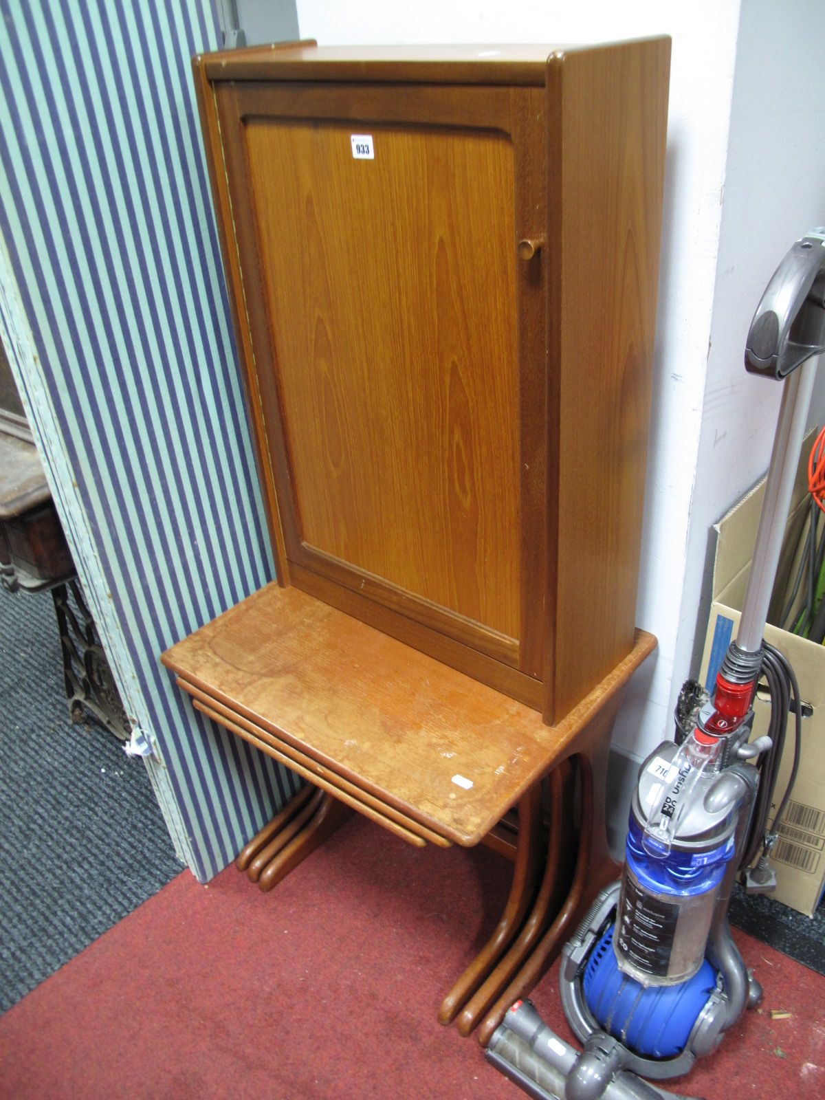 A Circa 1970's teak Nest of Three Tables, plain tops on shaped ends, and a teak narrow cabinet