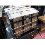 An Early XX Century Domed Travel Trunk, with wooden strapwork and twin leather carrying handles,