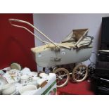 A Circa 1960's Tri-ang Dolls Pram, in cream, fitted with four Lines Bros tyres.