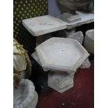 A Hexagonal Poured Concrete Bird Bath, on pedestal, decorated with fleur de lys base, together