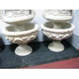 A Pair of Poured Concrete Pedestal Urns, decorated with leaf and foliate moulding.