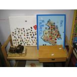 A Large Quantity of Enamel Pin Badges on a polystyrene board A box and a map of Mallorca. A wide