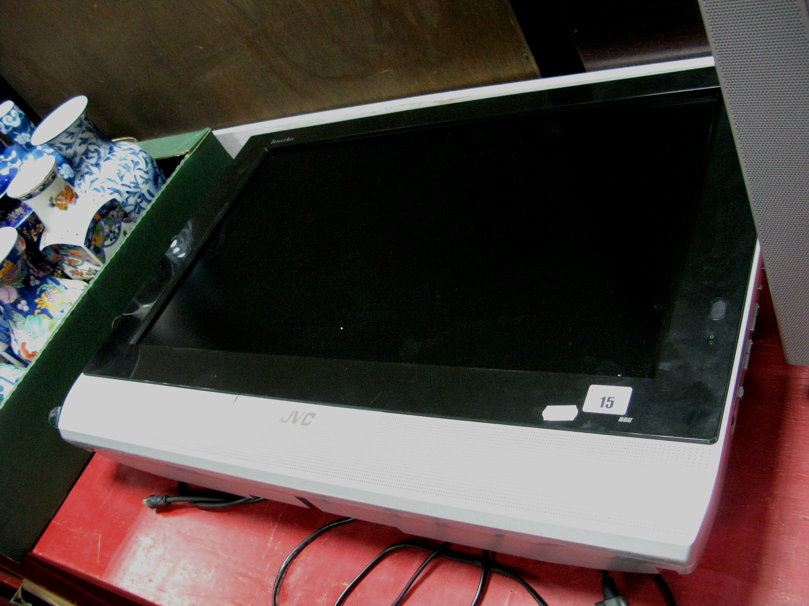 A JVC InteriArt 26" Flatscreen TV, in silver (with stand and remote).