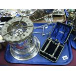 A Silver Plated Table Heater, by Elkington, a silver plated bottle holder and a cased pair of