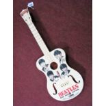 A 1960's Selcol Toy Guitar, bearing "The Beatles" and four pictures to front, no obvious cracks,