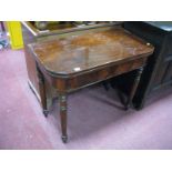 A XIX Century Mahogany Fold Over Tea Table, with a rectangular top, on turned legs.