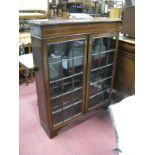 Edwardian Inlaid Bookcase, with a moulded top, astragal glazed doors, on bracket feet.