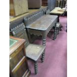 A XIX Century Oak Hall Table, with a low back, carved wheel decoration, carved apron, on bobbin