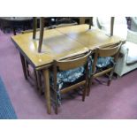 1970's Teak Draw Leaf Table, together with four chairs, all with rails backs.