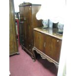 A Mid XX Century Mahogany Cocktail Cabinet, having twin doors over carved apron on cabriole legs,