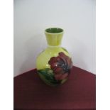 A Moorcroft Miniature Baluster Vase, decorated with the Hibiscus pattern on yellow ground, paper