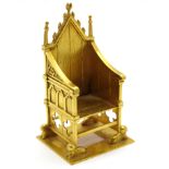 A 9ct Gold Miniature Model of The Coronation Chair, complete with stone, 4.5cms high. *The