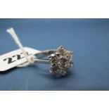 A Modern 18ct White Gold Diamond Set Flowerhead Cluster Ring, the graduated brilliant cut stones