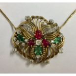 A Diamond, Ruby and Green Tourmaline Set Cocktail Pendant/Brooch, of openwork shaped design, claw